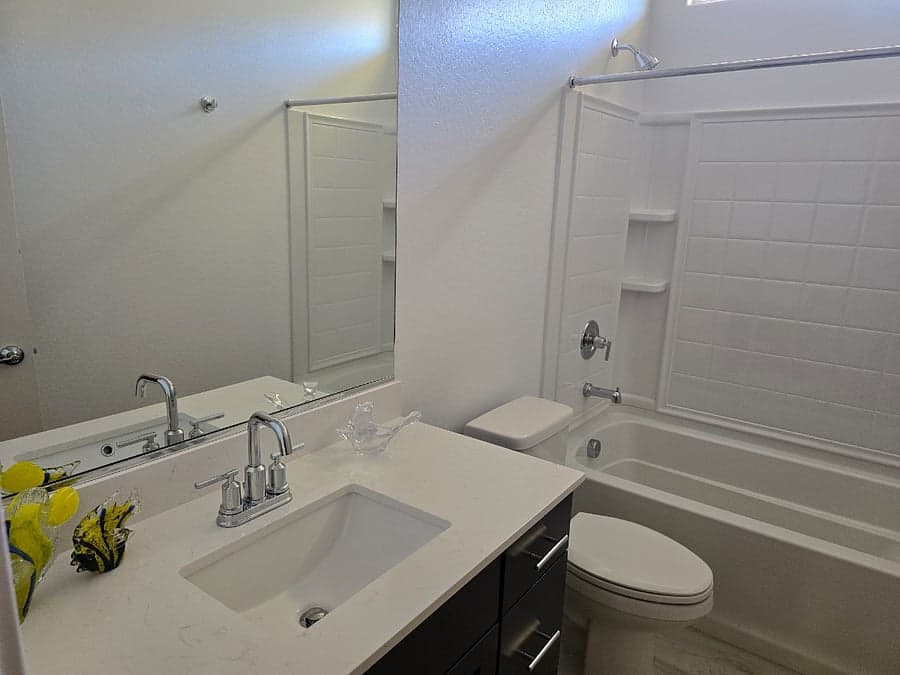 Bathroom with quartz vanity and tub-shower combo