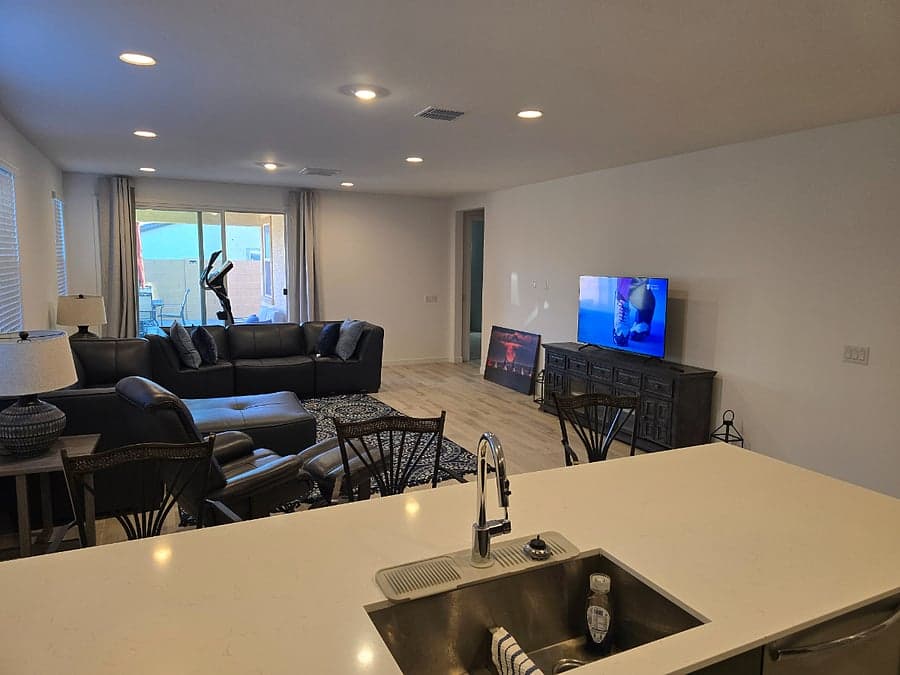 Open great room with leather sectional and smart TV