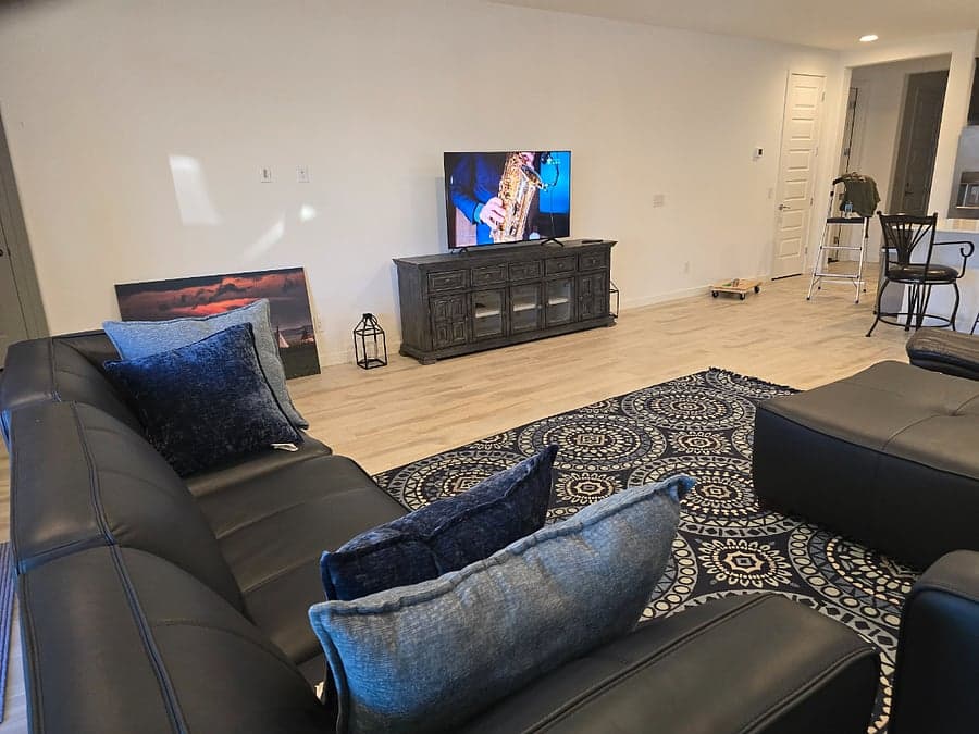 Living room with leather sectional and entertainment center